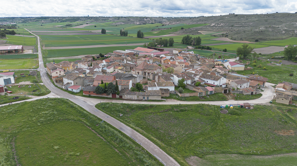 Panorámica aérea general de Villaconancio, rodeado de campos verdes y cerros.