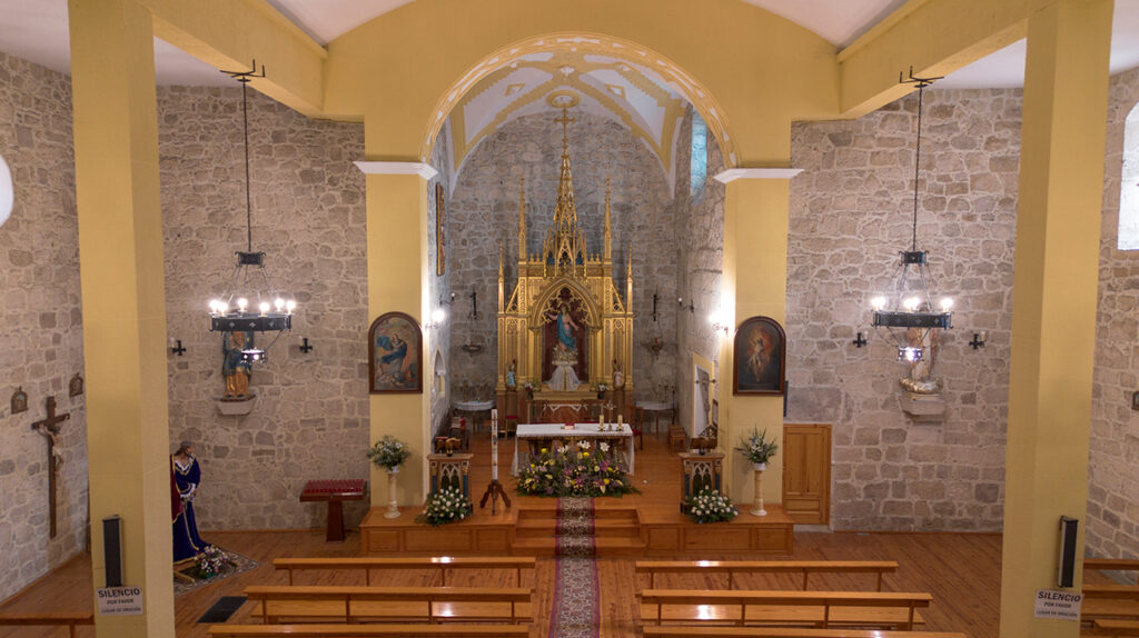 Interior de la iglesia de la Asunción de Antigüedad. La cubierta es una renovación reciente y preside la nave un retablo neogótico.